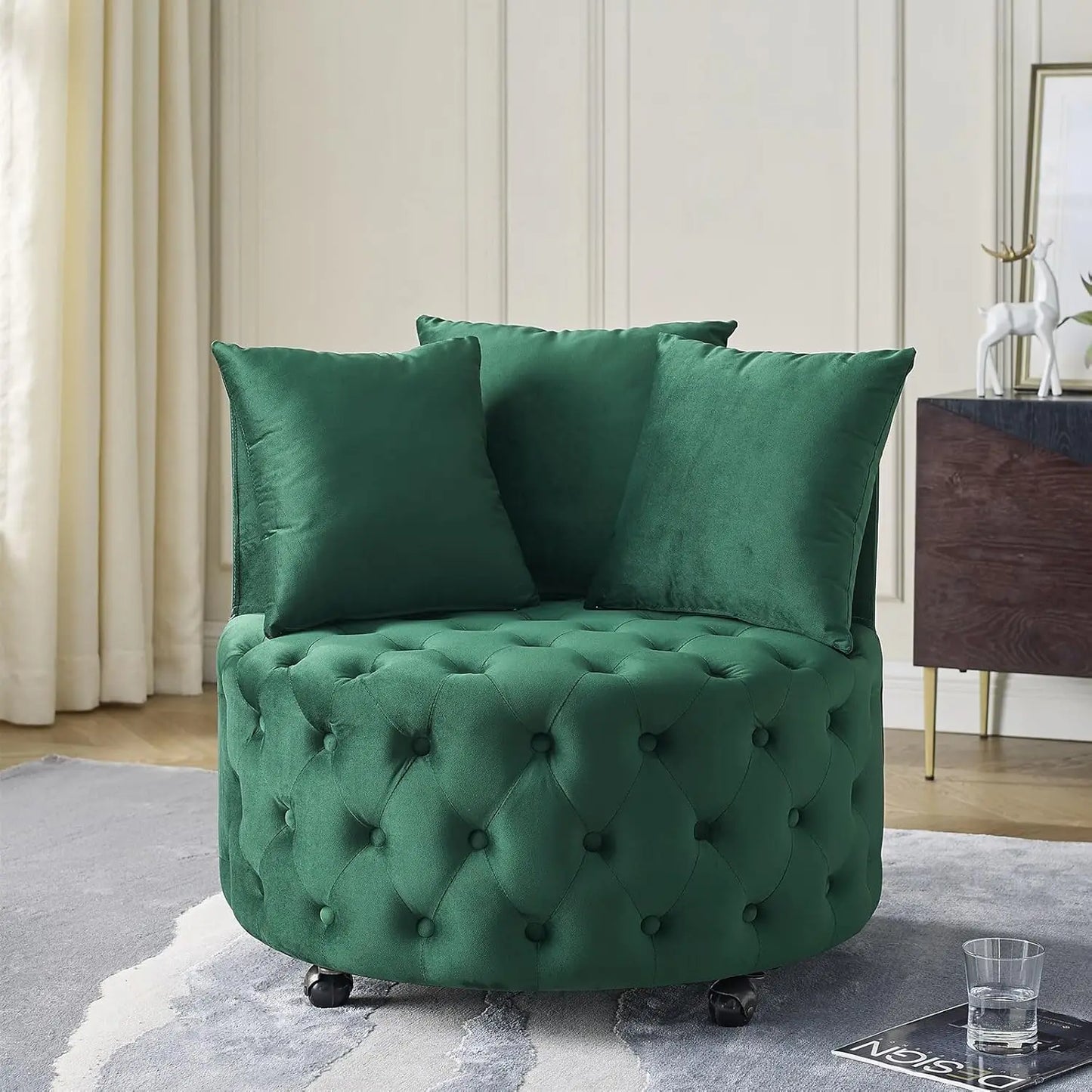 Green tufted armchair with cushions in a room setting