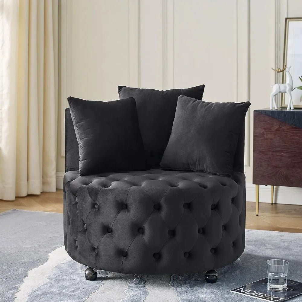 Dark gray tufted armchair with three black pillows in a room setting.